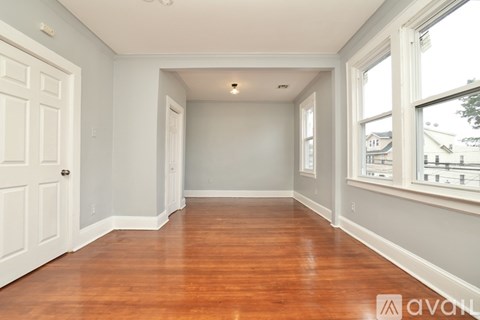 A room with wooden floors and white walls.