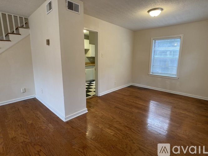 A room with wooden floors and a window.