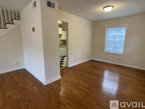 A room with wooden floors and a window.