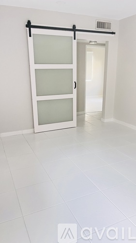 A white door with frosted glass panels is open.