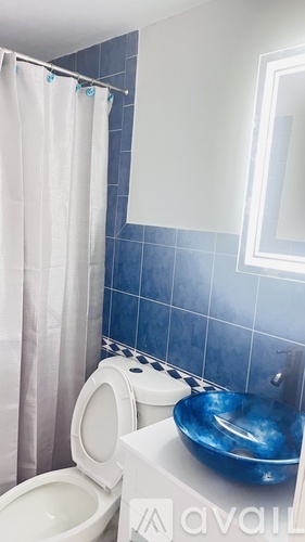 A white toilet and sink in a bathroom.
