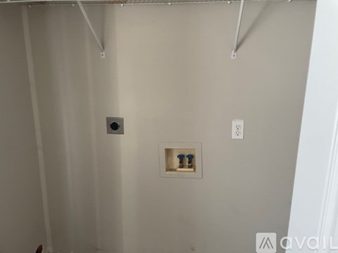 A bathroom with a toilet paper holder and a light switch.