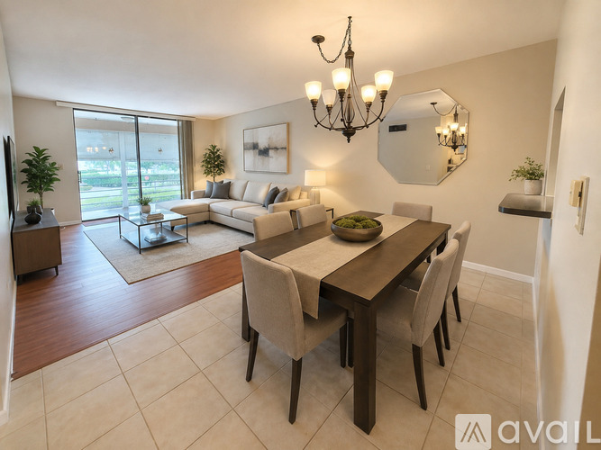 A well-lit dining room with a wooden table and chairs.