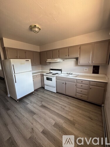 A kitchen with a white fridge and a white oven.