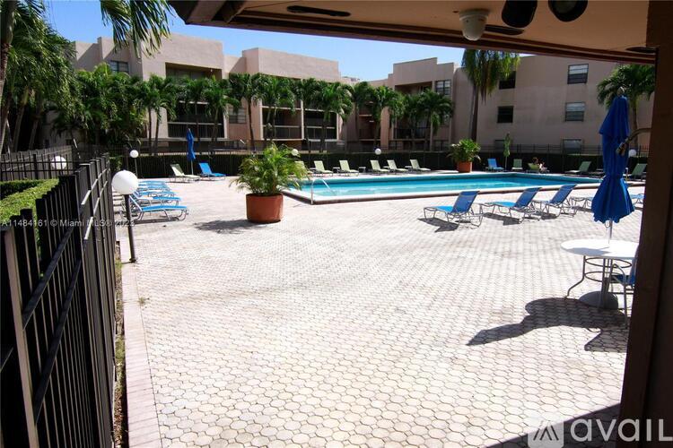 A pool area with a tiled floor and a pool table.