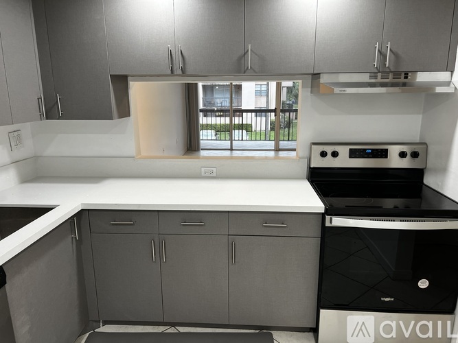 A modern kitchen with a dishwasher and a stove top oven.