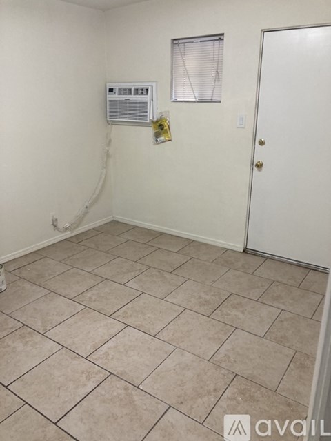 A room with a tiled floor and a door.
