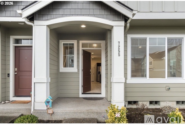 A house with a brown door and a small porch.