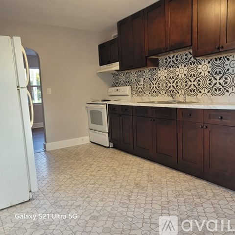 A kitchen with a white fridge and a white stove top oven.