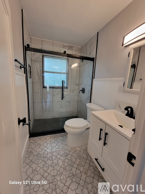 A bathroom with a Galaxy S21 Ultra 5G phone.