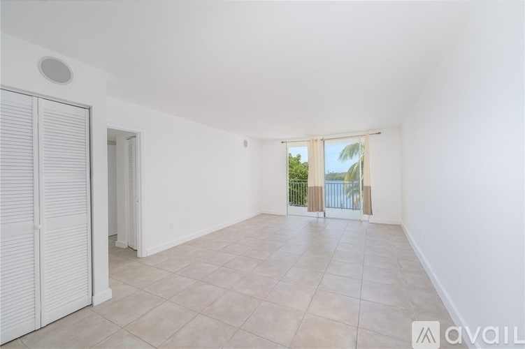 A spacious room with white walls and a tiled floor.