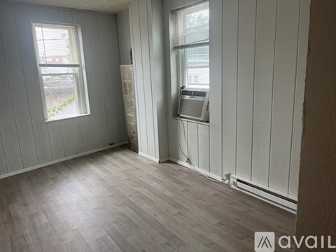 A living room with a couch, coffee table, and a television.
