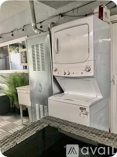 A white oven and microwave are on a shelf in a kitchen.