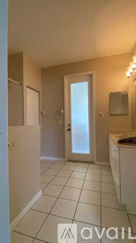 A hallway with a washing machine in the corner.