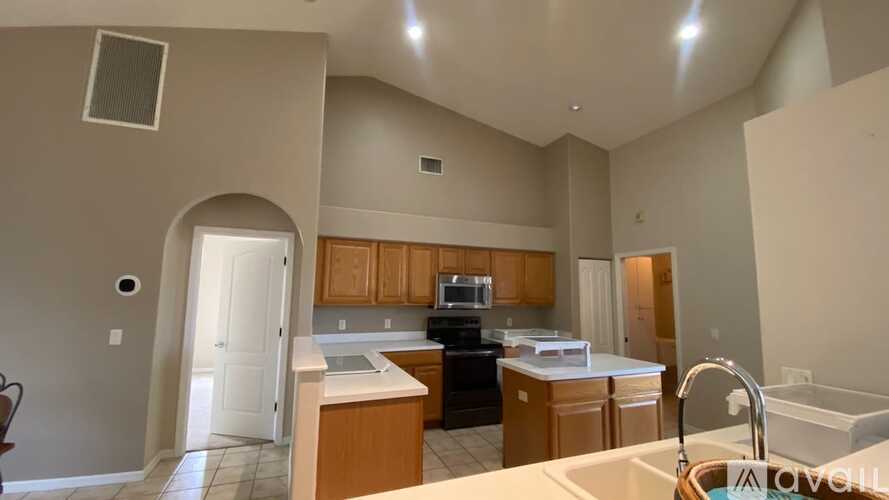 A kitchen with wooden cabinets and a white countertop.