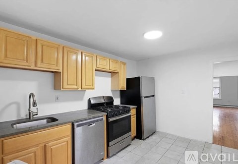 A kitchen with wooden cabinets and black appliances.