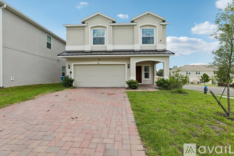 A two-story house with a garage is for sale.