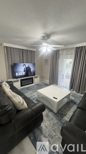 A living room with a television and a couch.