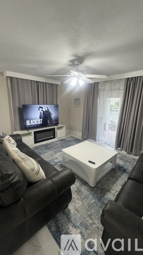 A living room with a television and a couch.