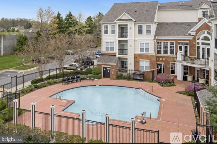 A large, multi-story residential building with a pool in the backyard.