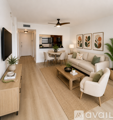 A living room with a white couch, a wooden coffee table, and a flat-screen TV mounted on the wall.