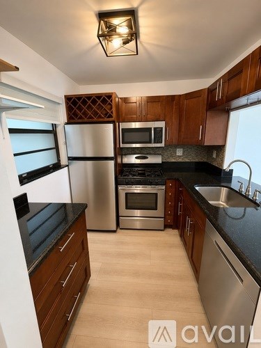 A kitchen with wooden cabinets and stainless steel appliances.