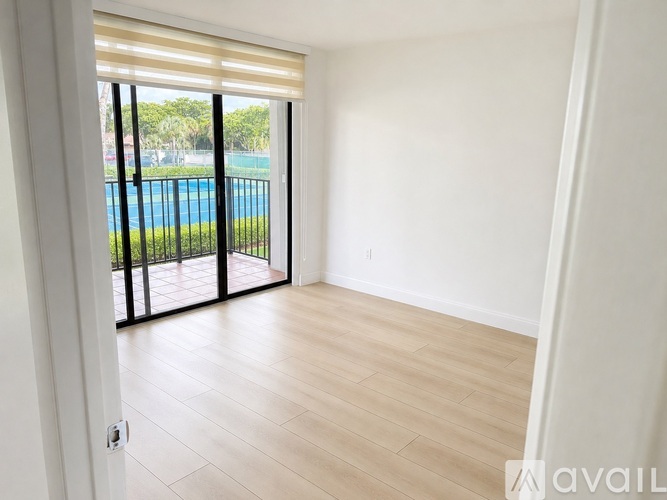 A room with a sliding glass door leading to a pool area.