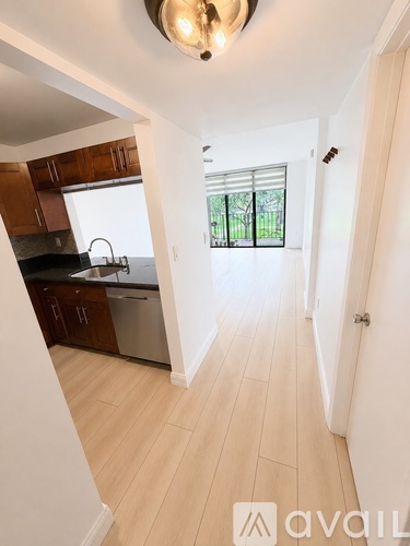 A hallway with a door leading to a balcony.