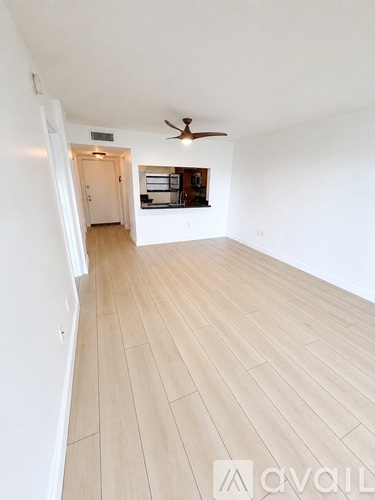 A room with a ceiling fan and light switch.