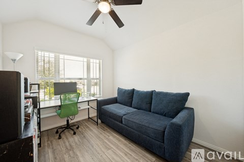 A living room with a blue couch and a green chair.
