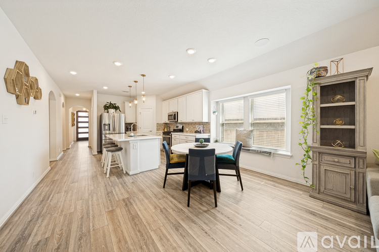 A modern kitchen with a dining table set for four.