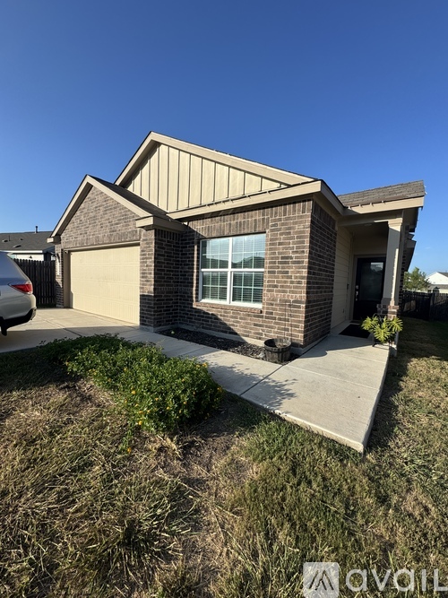 A house with a garage and a driveway in front.