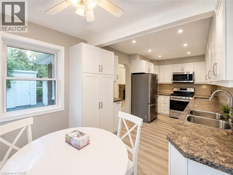 A well-lit kitchen with a table and chairs.