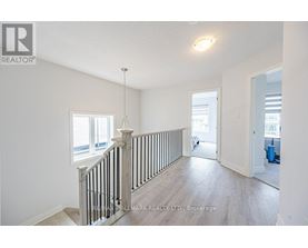 A spacious room with a staircase leading to the second floor.