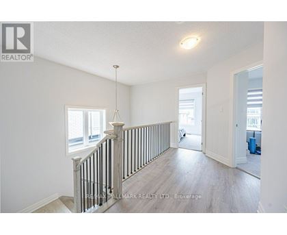 A spacious room with a staircase leading to the second floor.