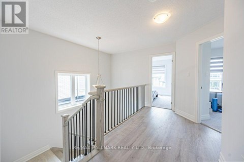A spacious room with a staircase leading to the second floor.