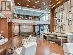 A modern living room with a dining area and a staircase.