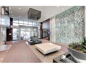 A modern lobby with a large glass wall and a reception desk.