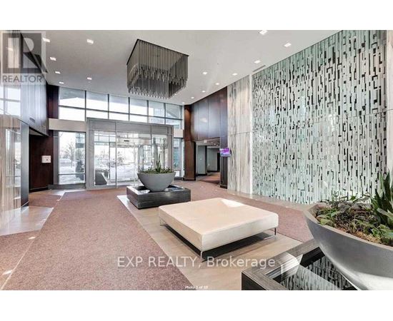 A modern lobby with a large glass wall and a reception desk.