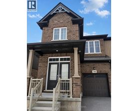 A house with a black front door and a garage door.