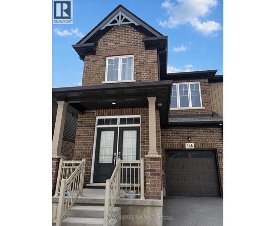 A house with a black front door and a garage door.
