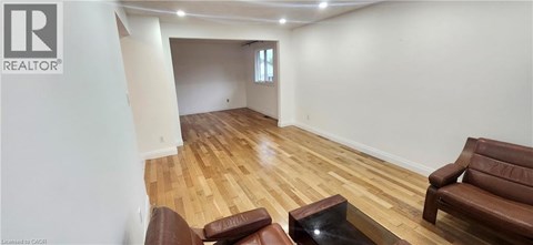 A living room with a brown leather couch and a glass coffee table.
