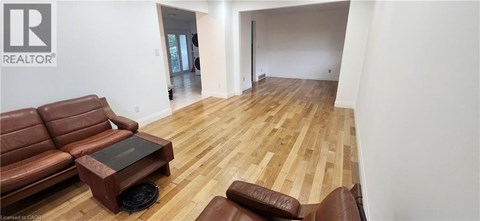 A living room with a brown leather couch and coffee table.