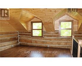 A wooden room with windows and a sign that says "REALTOR".