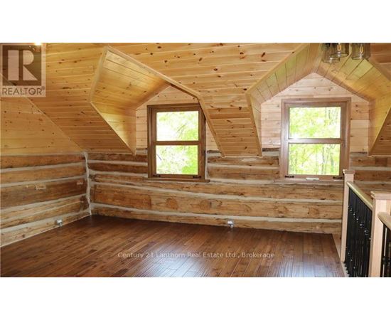 A wooden room with windows and a sign that says "REALTOR".