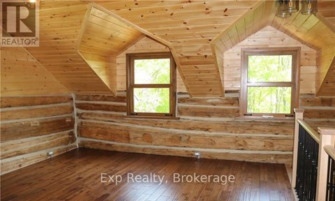 A wooden room with windows and a sign that says "REALTOR".