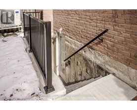 A black metal railing on a concrete staircase.
