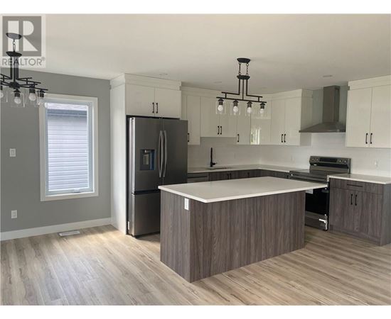 A modern kitchen with a large island in the center.