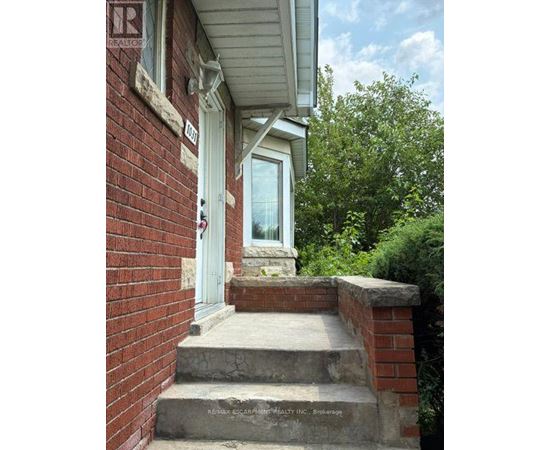 A house with a white door and a brick wall.