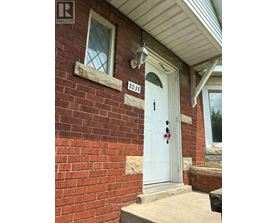 A house with a white door and a number 1031 on the wall.